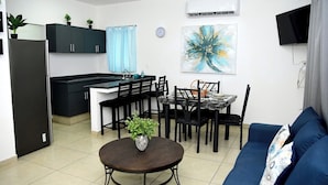 A compact living space with a kitchenette, dining area, and a sofa. - Private Rooftop Terrace · BBQ · City Views · 2BR Mazatlán (Mazatlán)
