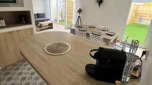 A modern kitchen with a central island, built-in appliances, and a view to the backyard.