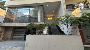 A modern building with large windows, a staircase, and a sign for 'Zesty.' - Zesty Hostel & Bistro (Nha Trang)