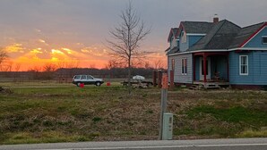 A house with a porch, a garage, and a driveway.