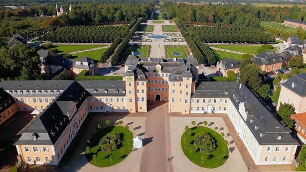 A large, symmetrical building with a central courtyard, surrounded by manicured gardens and a formal, geometric layout. - Hotel Altavilla (Schwetzingen)