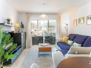 A modern living room with a sofa, coffee table, TV, and plants. - Alcazar by Interhome (Almuñécar)