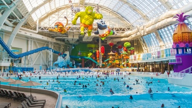 An indoor water park with multiple pools, slides, and large inflatable characters. - Cozy Chic 1 Bdrm King Suite - mins to NYC, MetLife (Belleville)