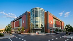 A modern building with a curved glass facade and a sign reading 'Prudential Center.' - Cozy Chic 1 Bdrm King Suite - mins to NYC, MetLife (Belleville)