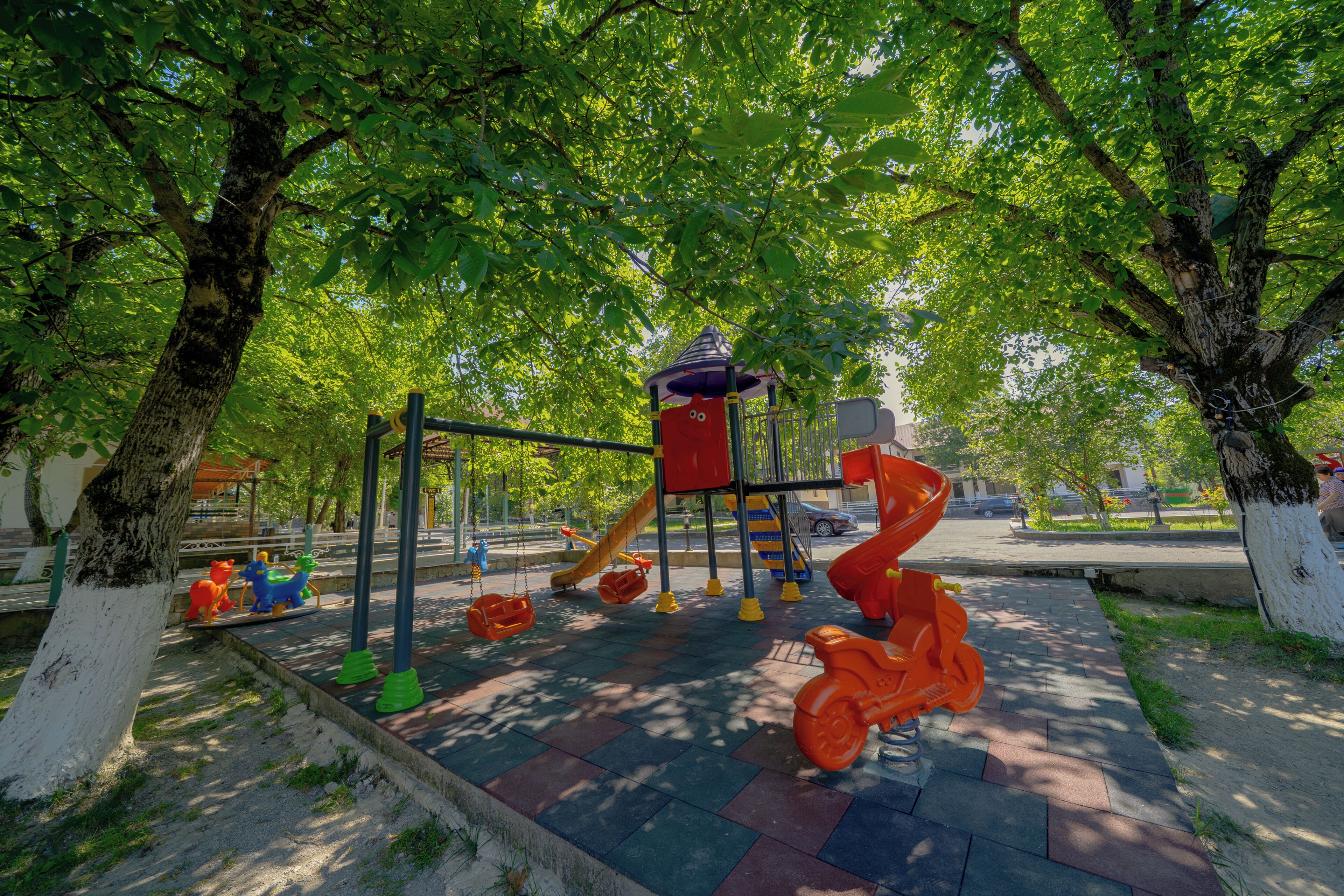 A playground with swings, slides, and climbing structures.