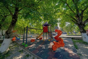 A playground with swings, slides, and climbing structures. - Quba Qala Resort (Quba)