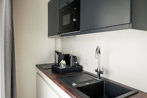 Apartemen Deluks | Dapur pribadi | Lemari es, microwave, kompor, dan mesin pencuci piring