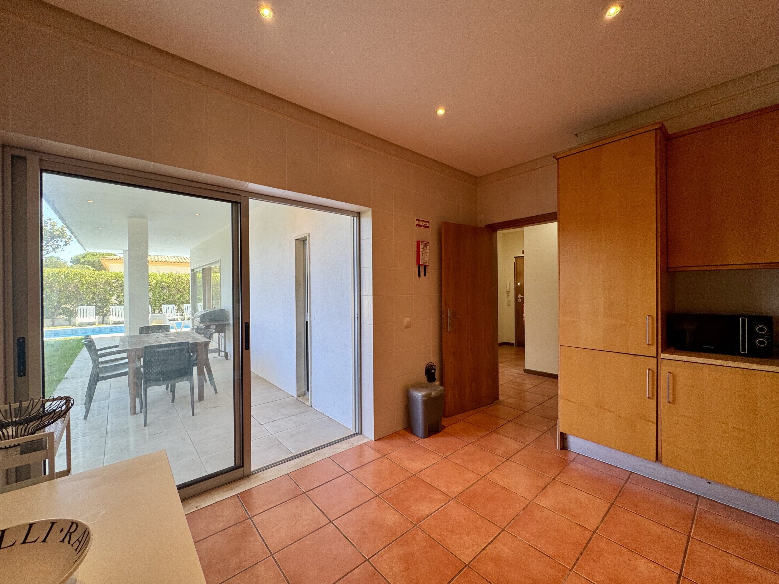 A modern kitchen with sliding glass doors leading to a patio area.
