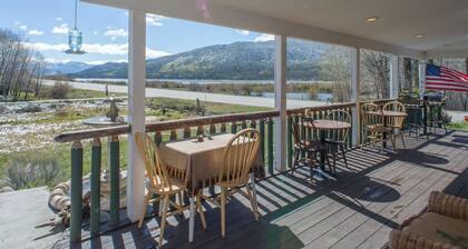 Romantic Twin Lakes lodge room with queen bed, porch & lake views