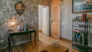 A room with a marble wall, a wooden door, a bookshelf, and a table with a chess set. - Guest Room “Chambre du Parc”: Mountain View, Shared Terrace, Wi-Fi (Saint-Albin-de-Vaulserre)