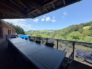 An outdoor dining area with a view of a forested valley. - Large house with garden and terrace in Lapoutroie (Lapoutroie)