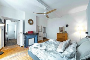 A bedroom with a bed, dresser, and a fireplace. - L'Escapade Minervoise, the ideal place to stay with family or friends (Laure-Minervois)