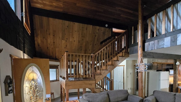 A wooden interior with a staircase, a sofa, a chair, and a table. - ~ Riverfront, Hot Tub, Mountain Views, 8 Beds ~ (Cascade)