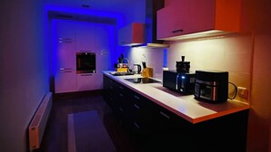 Eine moderne Küche mit Backofen, Mikrowelle und Kaffeemaschine.