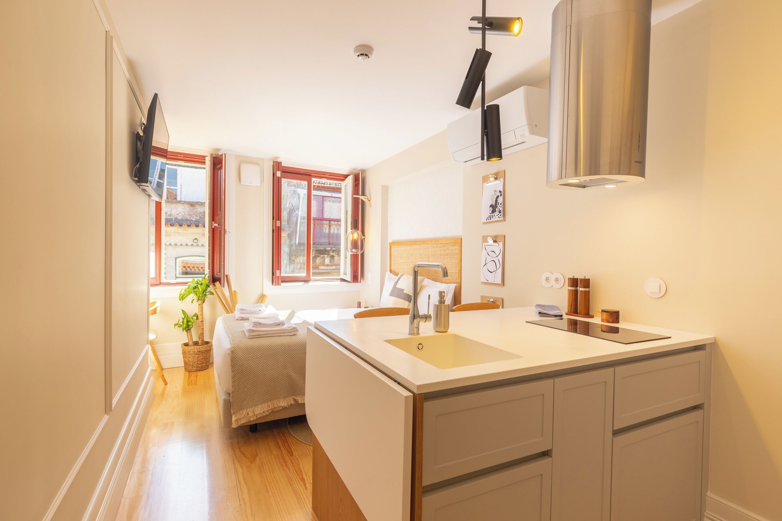 A modern kitchen with a central island, a built-in oven, and a window with a view.