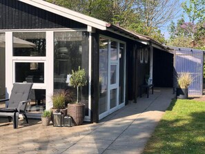 A modern building with large windows, outdoor seating, and potted plants. - 4 Star Holiday Home in Esbjerg V (Esbjerg)