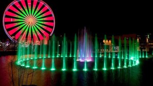 A large Ferris wheel and a fountain display at night. - The Ruby 111 (Pigeon Forge)
