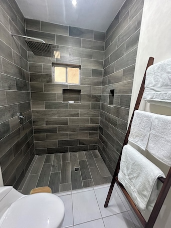 A modern bathroom with a shower, a toilet, and a towel rack.. Full House Steps from BBVA Stadium