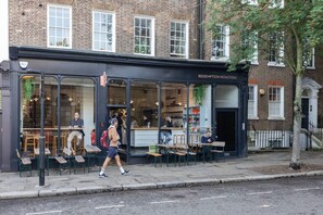 A brick building with a black awning labeled 'REDEMPTION ROASTERS.' - Hardwick Street III - Two Bedroom Apartment, Sleeps 4 (London)