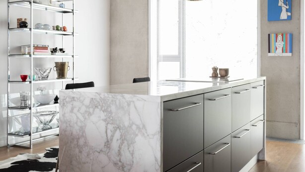A modern kitchen with a marble island, black pendant lights, and a stainless steel range hood. - Compton Street - Two Bedroom Apartment, Sleeps 4 (London)