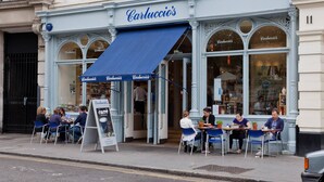 A café with outdoor seating, a blue awning, and a sign reading 'Carluccio's.' - Compton Street - Two Bedroom Apartment, Sleeps 4 (London)