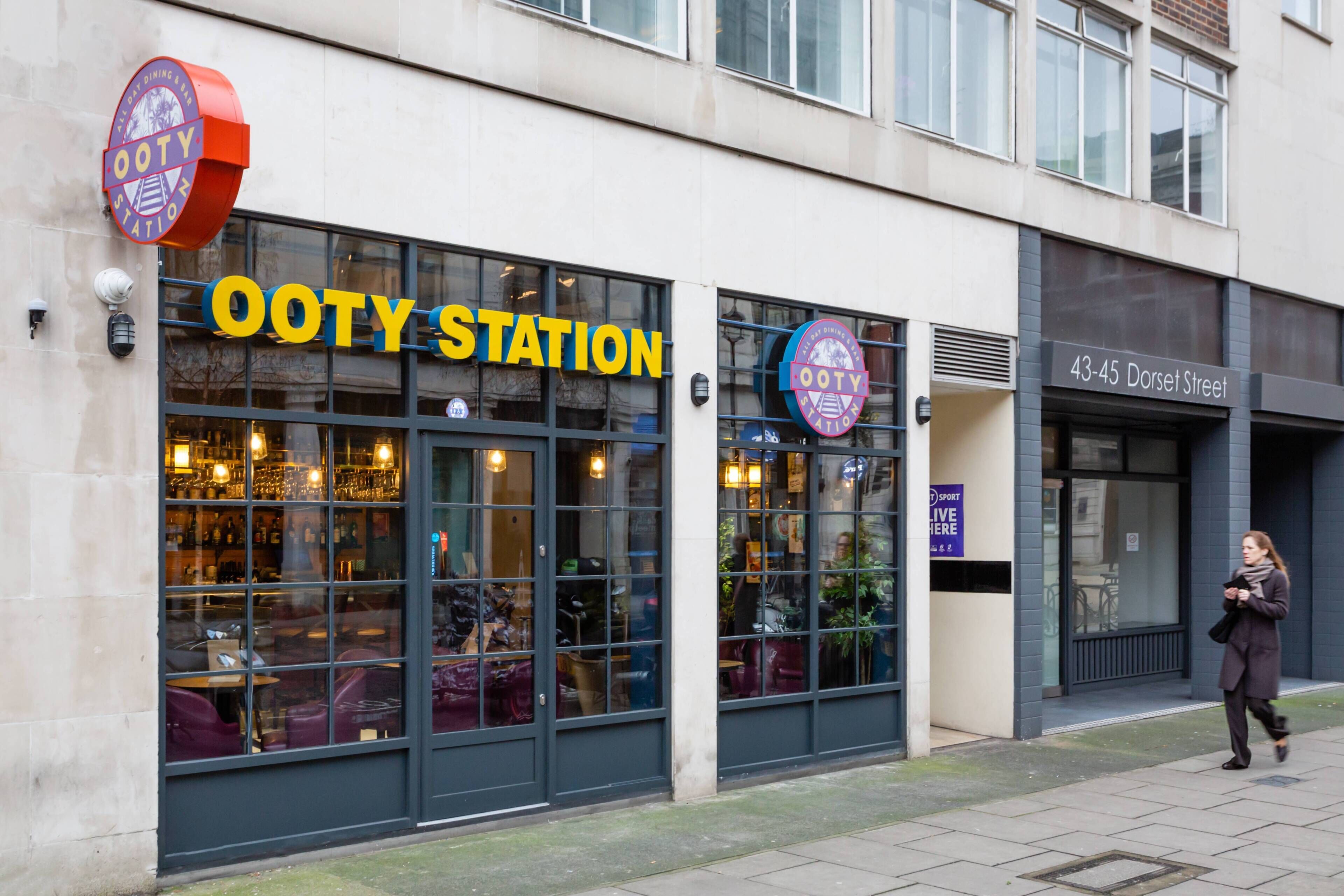 A building with a sign reading 'OOTY STATION' and another sign for '43-45 Dorset Street.'