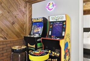 Arcade machines, a neon sign, and a wooden wall. - The Rad Pad - Arcades, Seasonal Pool (Boise)