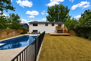A two-story house with a swimming pool, a deck, and a fenced yard. - Rad Pad - Arcades, Seasonal Pool (Boise)