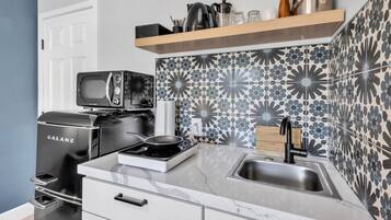 Una cocina moderna con una estufa Galanz, un microondas y un lavabo.