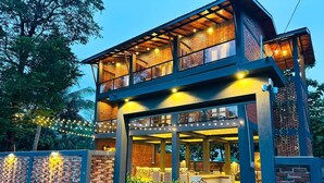A two-story building with a glass facade, a brick exterior, and a pool area. - Airport Hotel Transit 98  (Katunayake)