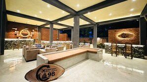 A spacious lounge area with a bar, seating, and a sign indicating 'Airport Hotel Transit 98'. - Airport Hotel Transit 98  (Katunayake)