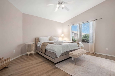 A bedroom with a bed, bedside table, bench, and a ceiling fan.. Glendale Pool Retreat Near Hiking and Dining