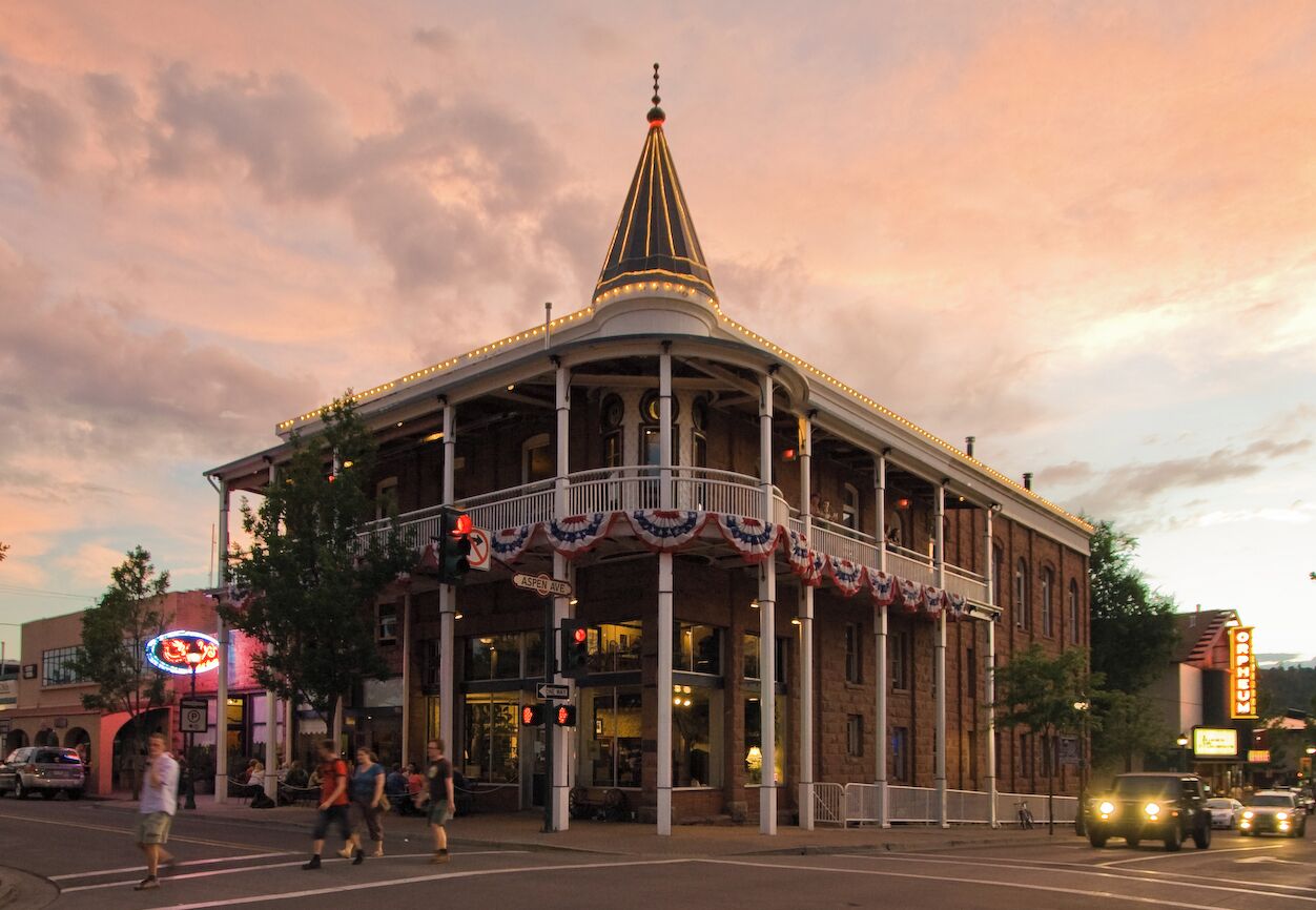 A historic building with a central dome, columns, and a balcony.