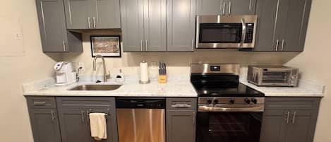 Coffee/tea maker, fridge, microwave, oven