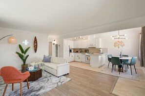 A modern apartment with a living room, dining area, and kitchen. - Scenic 2BR Stay w/ Ocean, Mountain & Sunset Views (Pacifica)