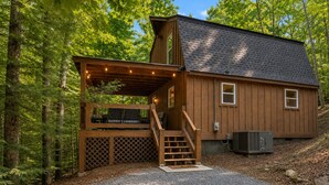 A wooden cabin with a porch, a staircase, and a gravel driveway. - Your Modern Creekside Retreat with Resort Perks! Modern 2bdrm + Open LoftTrundle (Ellijay)