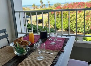 A balcony with breakfast items, a view of the ocean, and a railing. - BEACH FRONT STUDIO WITH TERRACE !!! SUPERB VIEW !!!!! (Sète)