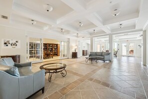 Eine geräumige Lobby mit einer Ledersofa, einem Couchtisch und einem Bücherregal.