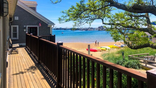 A wooden deck with a view of a beach and boats. - .3 Miles from MacMillan Pier with Parking! (Provincetown)