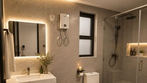 A modern bathroom with a glass shower enclosure, a toilet, a sink with a mirror, and a small window. - 1 bedroom syokimau near airport with Nairobi national park view. (Nairobi)