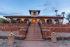 A building with a central staircase, stone walls, and arched windows. - Havasu Acoma - Pool, Spa, Game Room, Sleeps 16 (Lake Havasu City)