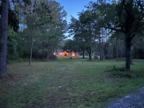 A house surrounded by trees with a well-maintained lawn.