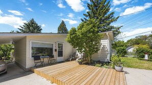 A house with a deck, a garage, and a small garden. - The Little Lighthouse (Sarnia)