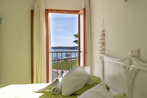 A hotel room with a bed, a view of the sea, and a balcony. - Skyline Cala Nau by Rentallorca (Cala Millor)