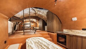 A modern kitchen with a marble countertop, wooden cabinets, and a built-in oven. - COMBINING AUTHENTIC PARISIAN CHARACTER WITH MODERN COMFORTS -MARAIS (Paris)