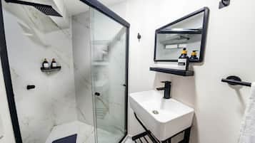 Habitación estándar, para no fumadores | Baño | Regadera, toallas, jabón, shampoo