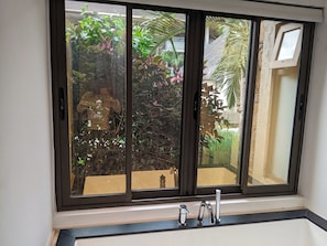A bathroom with a window, a sink, and a mirror. - Pool View Apartment at 'Domaine dès Alizées Club & Spa' (Grand Baie)