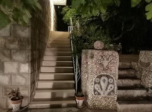 A staircase leading up to a stone wall with a decorative pattern.