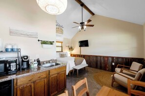 A kitchen with a coffee maker, sink, and wooden cabinets.