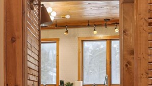 Un interior de madera con cocina, que incluye armarios, un lavamanos y una ventana.